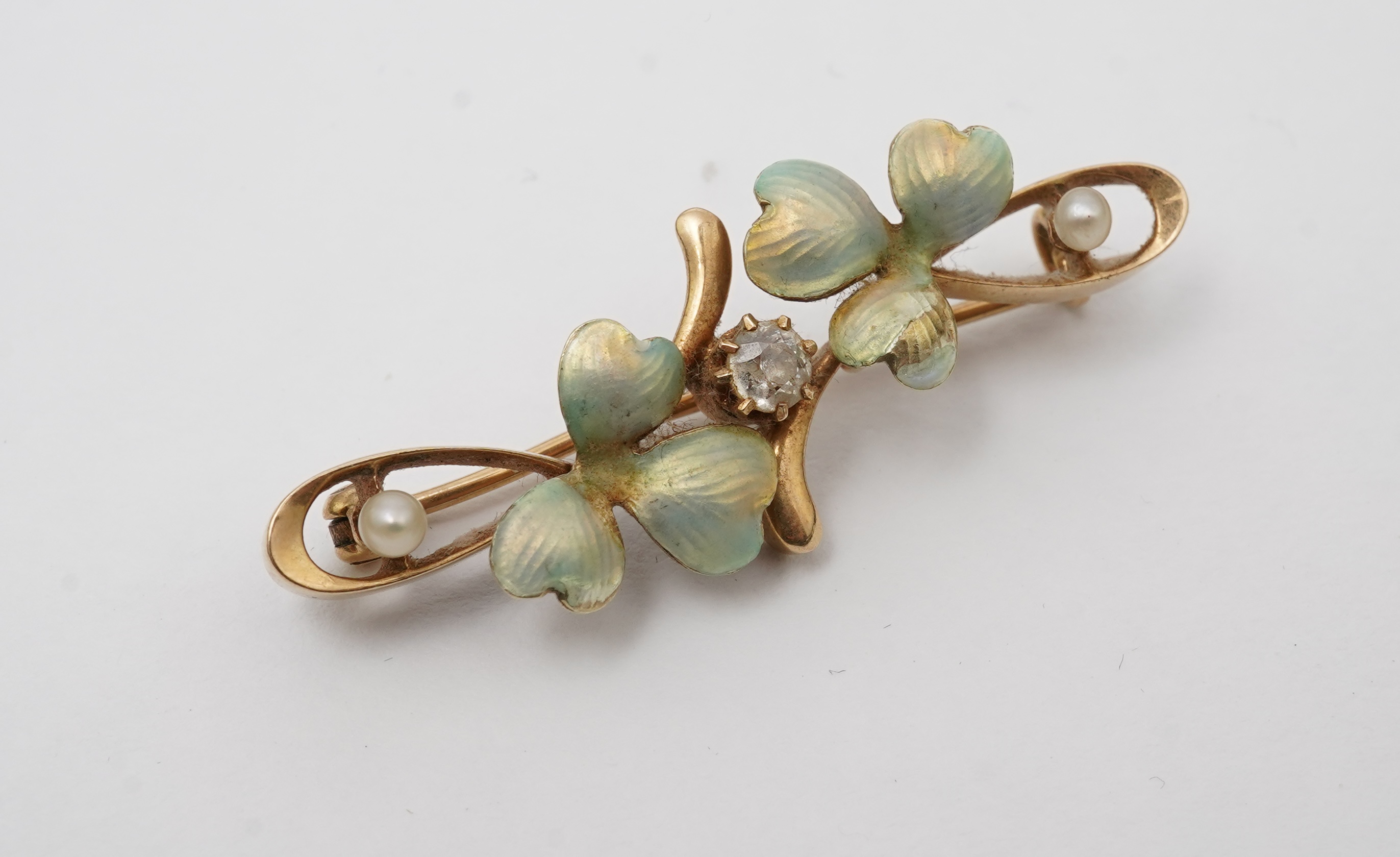 An Art Nouveau gold, enamel, seed pearl and diamond bar brooch, early 20th century